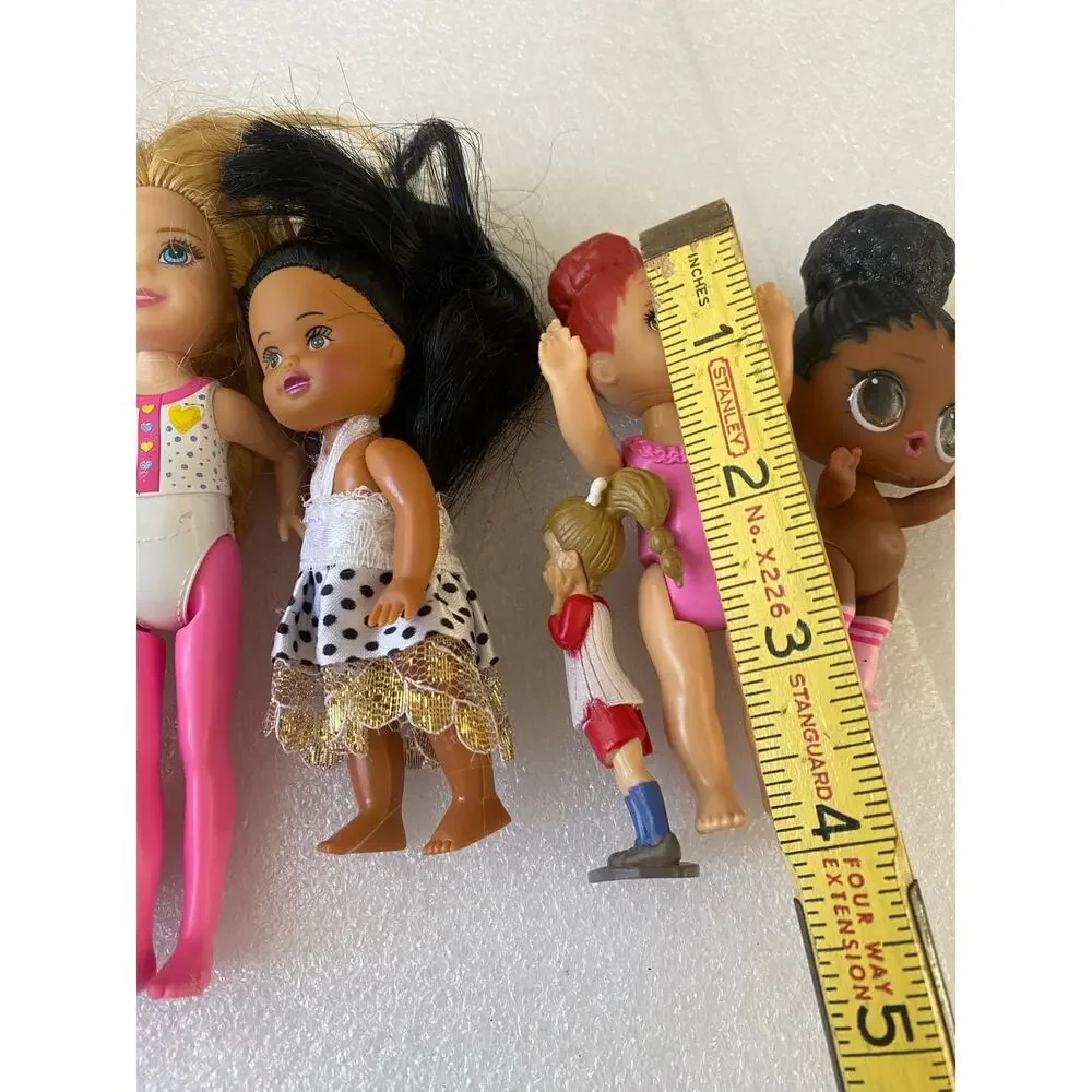 group of small Barbie Club Chelsea dolls and miniature figures in mixed outfits